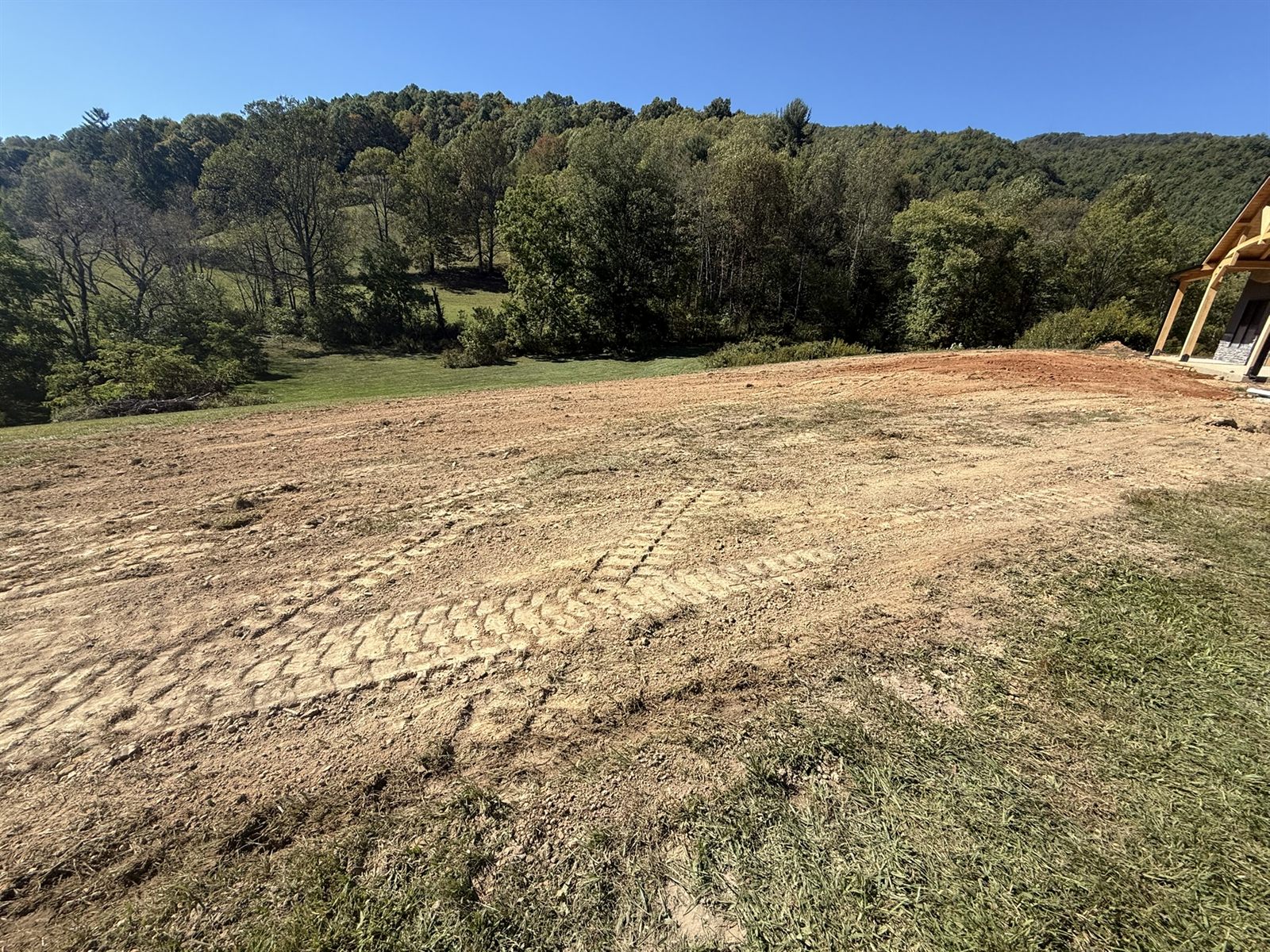 Freshly graded building pad with a mountain backdrop, Austin Grading & Land Management, Western North Carolina