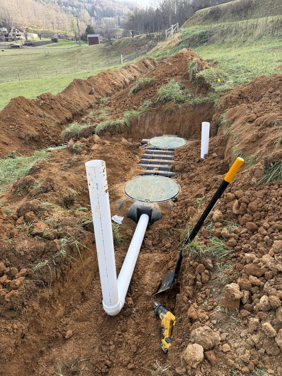 Septic tanks with risers and PVC plumbing set in an excavation, Western NC
