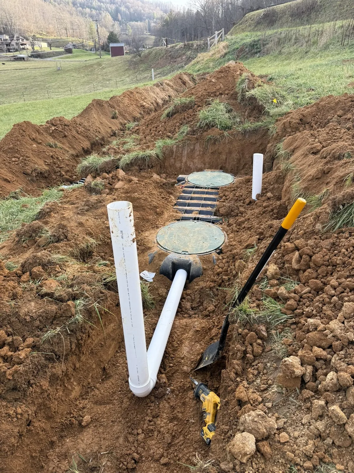 Septic tanks with risers and PVC plumbing set in an excavation, Western NC