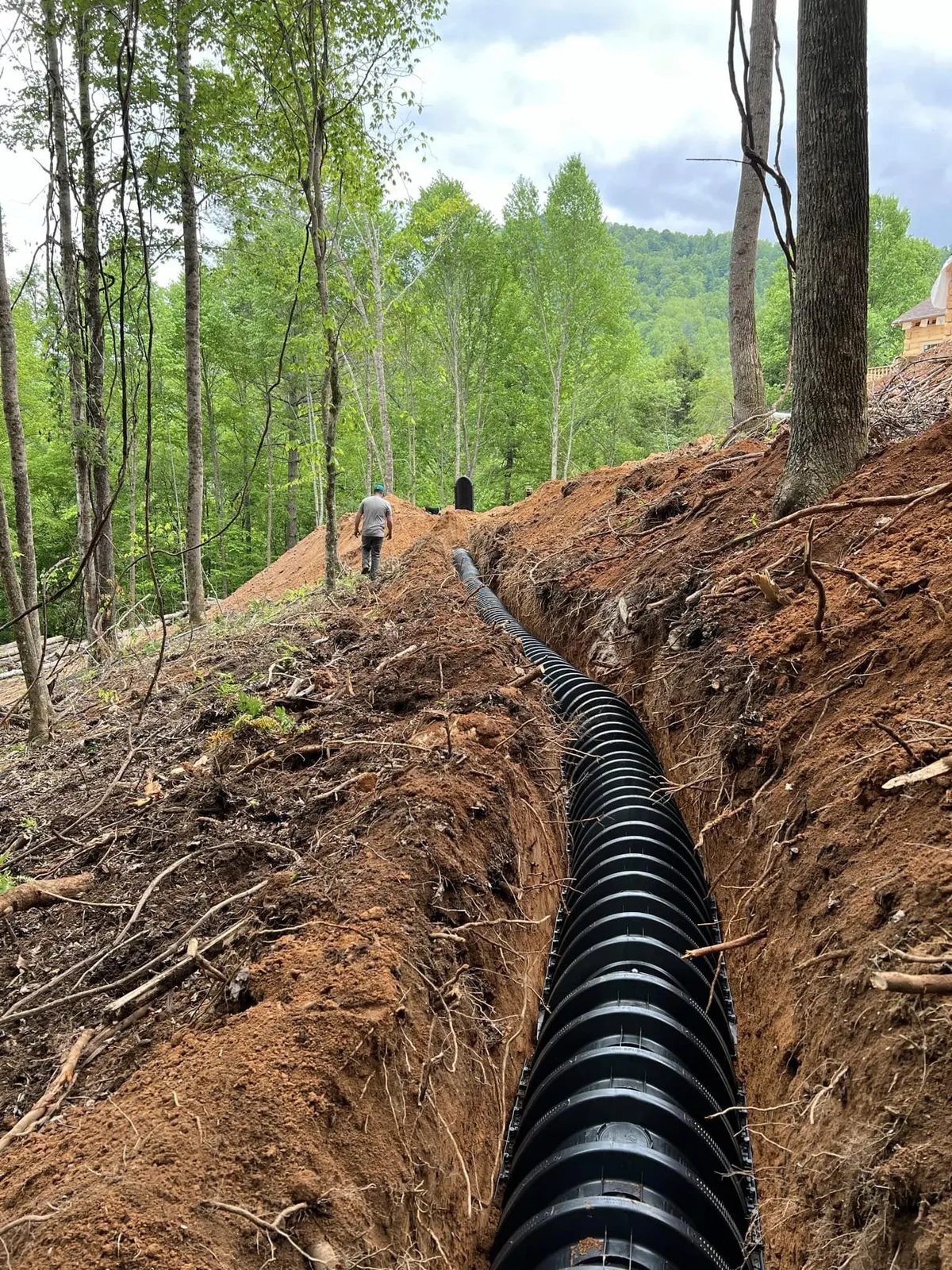 Drainage line run down a slope to control runoff on a Western NC site