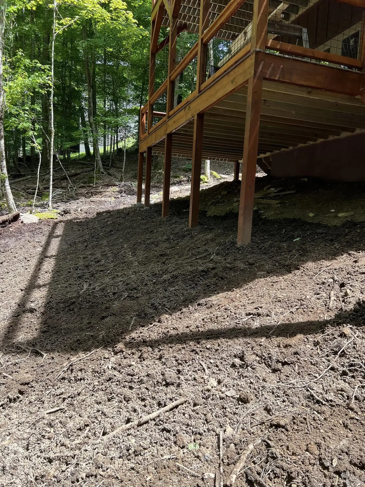 Freshly final-graded ground around the porch and deck posts