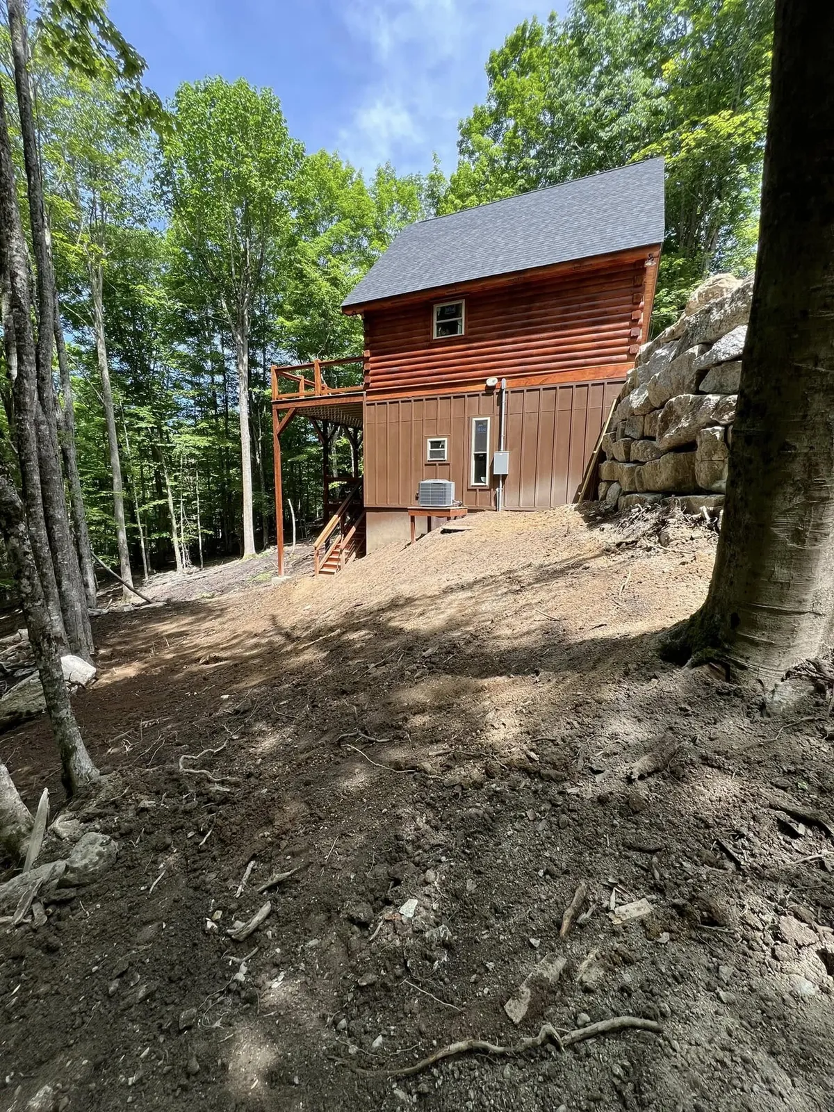 Site regraded around a finished home after septic and drainage work near Burnsville, NC