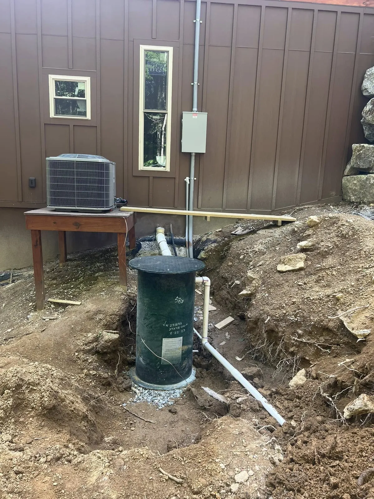 Septic pump riser with water line and power connections run to the house
